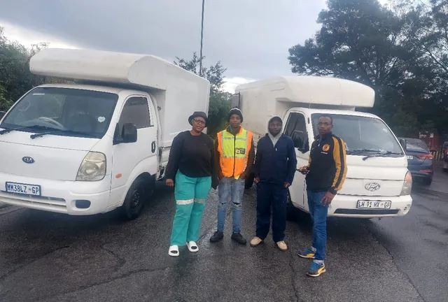 The Lewin Projects and Logistics moving team standing in front of two loaded bakkies before a job in Gauteng